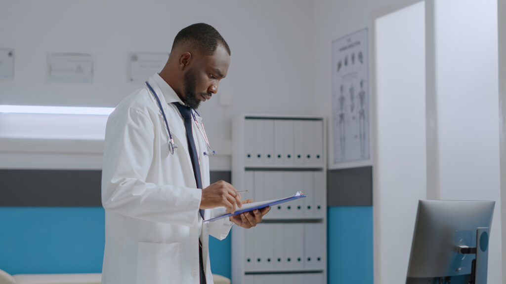 african-american-specialist-doctor-checking-sickness-report-documents-analyzing-medical-expertise-computer-while-working-healthcare-treatment-hospital-office-medicine-service
